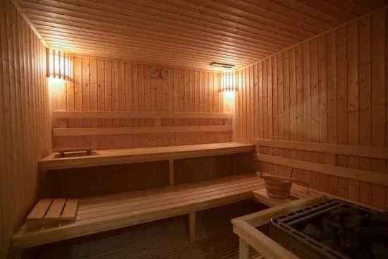 Traditional Sauna Interior Design Interior view of a traditional Finnish sauna with wooden benches and stone heater